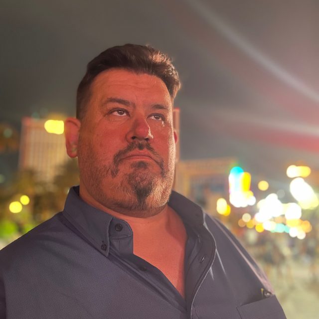Chris Baugus at night on a city street